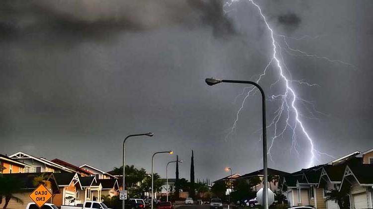 Lightning striking in a residential neighborhood.